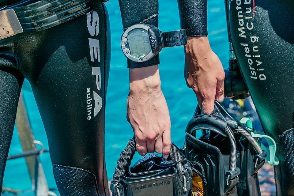 Two divers holding fins on the way to Deep Diver Speciality
