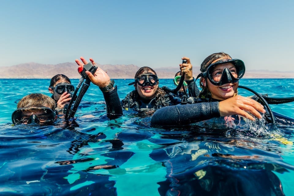 guided-dive-eilat divers on the ocean surface getting ready to dive
