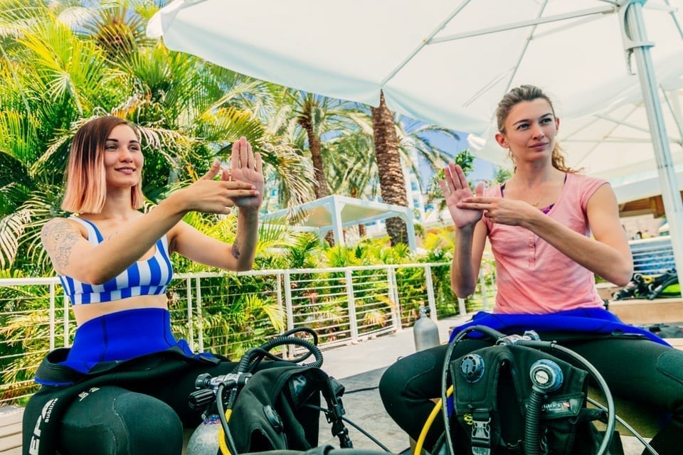 two girl divers on a refresher dive briefing